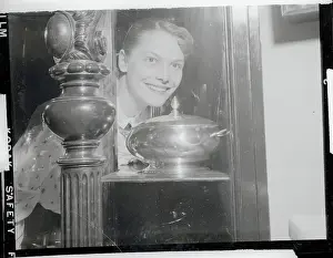 Ice Skating Champ Carol Heiss Admiring Trophies