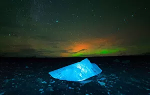 Global Landscape Views Gallery: Iceberg under Aurora borealis at Jokulsarlon, Iceland