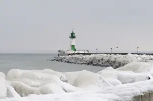 Iced wharf and a lighthouse in the port of Sassnitz on Ruegen Island, Mecklenburg-Western Pomerania, Germany, Europe