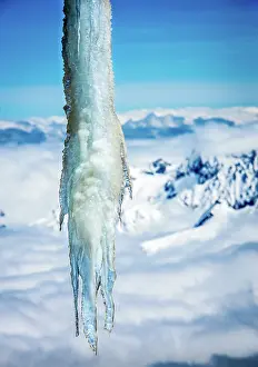 Prints of An icicle high above the clouds at the Aiguille du Midi station, Chamonix, France Travel Imagery Prints: Icicle above clouds