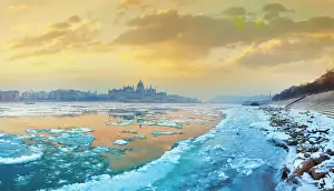 The icy Danube river and the Parliament of Hungary in Budapest at dawn in the winter