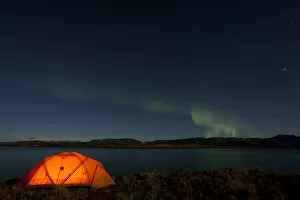 Illuminated expedition tent, Northern lights, Polar Aurorae, Aurora Borealis, green, reflections in water, Lake Laberge