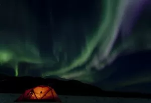 Images Dated 7th April 2010: Illuminated expedition tent and traditional wooden snow shoes, Northern or Polar Lights