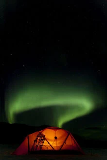 Northern Lights Collection: Illuminated expedition tent and traditional wooden snow shoes, Northern or Polar Lights