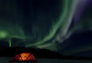 Polar Lights Prints: Illuminated expedition tent and traditional wooden snow shoes