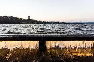 Icicle Prints: Illuminated icicles on bridge against the Leifeng Pagoda by the West Lake