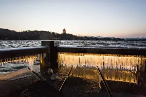 Icicle Prints: Illuminated icicles on bridge against the Leifeng Pagoda by the West Lake