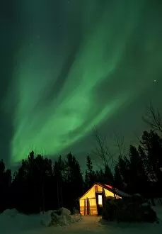 Northern Lights Collection: Illuminated, lit wall tent, cabin with swirling northern polar lights, Aurora Borealis, green