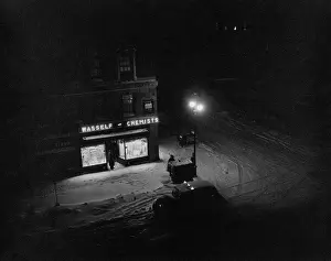 Huty37481 Prints: Illuminated Street Corner With Chemist's Shop