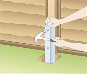 Human Hand Prints: Illustration of using claw hammer to mark fixing holes in fence spur and wood post