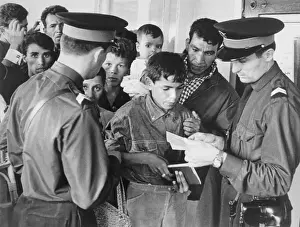 Immigration Officers Reviewing a Person's Papers