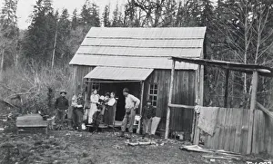 Log Cabin Prints: Indian Logger Stands In Front Of Home