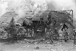 Indonesian Soldiers Check Burning House