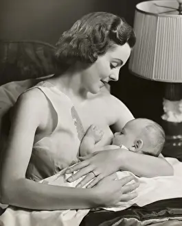 Infant being nursed by mother