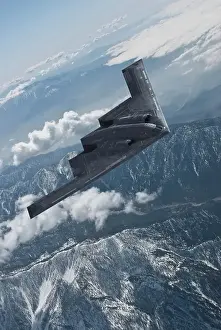 Airplane Prints: Inflight view of a USAF Northrop Grumman B-2A Spirit stealth bomber over mountains