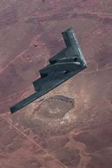 Airplane Prints: Inflight view of a USAF Northrop Grumman B-2A stealth bomber over the Barringer Meteor Crater in Arizona