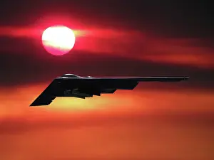 Airplane Prints: Inflight view of a USAF Northrop Grumman B-2A stealth bomber in a sunset