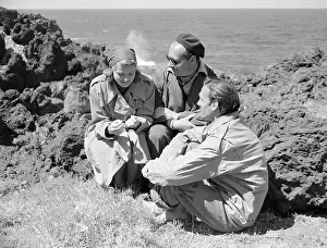 Prints of (Original Caption). Island Of Stromboli, Off Sicily: Make Film On Italian Island A Timeless Icon: Ingrid Bergman with Roberto Rossellini and Mario Vitale on Coast