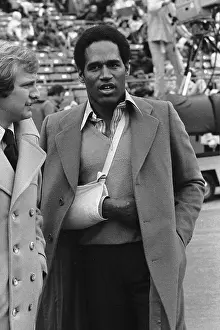 Injured O.J. Simpson Watches the Game from the Sidelines