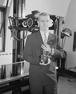 Inventor Barry Devine Holding Portable X-Ray Unit