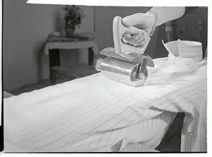 Nuremberg Prints: Inventor Demonstrating Use of a Electric Roller Iron