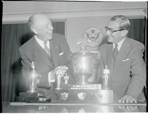 Irving Berlin and Wilber Brucker Standing by Trophies