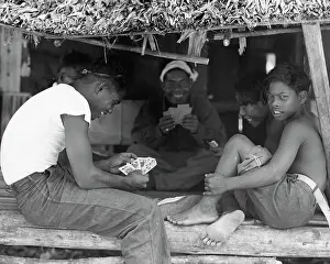 Island Natives Playing Cards in Makeshift Hut