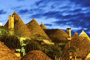 Images Dated 24th April 2015: Italy, Apulia, Alberobello, Traditional roofs of trulli houses at sunset