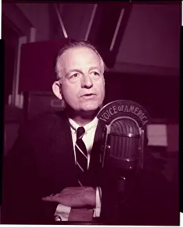 J. R. Poppele Sitting at Microphone