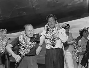 Jack Benny Playing Violin While Errol Flynn Covers Ears