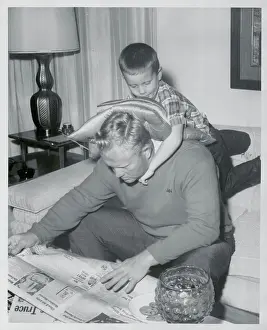 Jack Nicklaus Reading Newspaper with Son on His Back