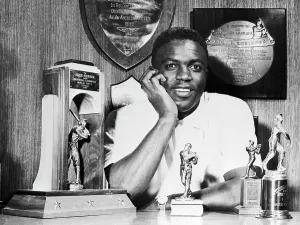 Stan Musial Prints: Jackie Robinson at Home With his Various Trophies
