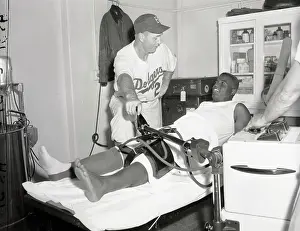 Jackie Robinson Lying Down for Knee Treatment
