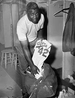 Jackie Robinson Putting Uniform into Bag