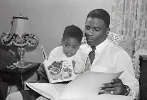 Jackie Robinson Reading Alongside His Young Son