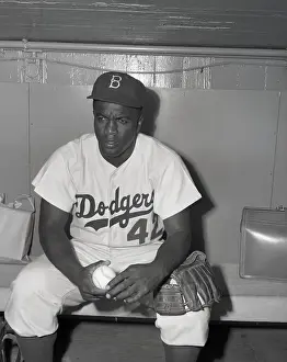Jackie Robinson Sitting on Sidelines in Uniform