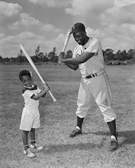 Jackie Robinson Sr. and Jr. on Field with Baseball Bats