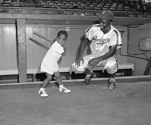 Jackie Robinson Watching His Son Swinging Bat