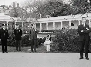 Jacqueline Bouvier Kennedy Stooping in Garden with John Fitzgerald Kennedy Jr