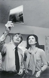 Jacqueline Kennedy Onassis and Bryan Holme Examining Photos