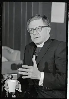 James A. Pike Gesturing and Holding Cup While Speaking to Press