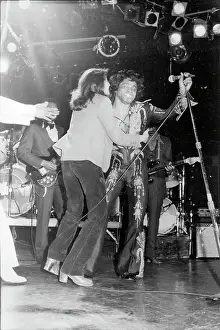 Prints of CIRCA 1980: Soul singer James Brown gets attacked for a kiss by an amorous fan who jumped on stage from the audience in circa 1980. (Photo by Michael Ochs Archives/Getty Images) Soul Power: A Visual Journey Through the Godfather of Soul’s Electrifying Legacy: James Brown Kiss