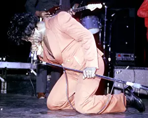 Prints of RESEDA, CA - JANUARY 31: Godfather of Soul James Brown gets down his knees as he performs onstage at the Country Club on January 31, 1982 in Reseda, California Soul Power: A Visual Journey Through the Godfather of Soul’s Electrifying Legacy: James Brown Performing At The Country Club