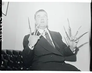 James Delaney Holding Switchblade Knives
