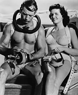 Jane Russell and Richard Egan Sitting on Boat With Fellow Actor