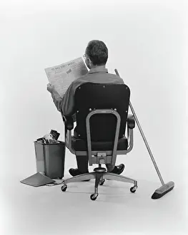 Only Mature Men Prints: Janitor sitting, taking a break, reading the Wall Street Journal newspaper, rear view