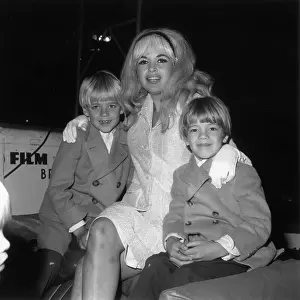 Prints of November 1966: American actor Jayne Mansfield smiles while sitting with her arms around her sons, Zoltan and Miklos, at a Santa Claus Lane parade, Los Angeles, California Hollywood's Blonde Bombshell in Focus: Jayne's Boys