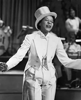 Screen Prints: Jenni Le Gon Singing in White Tuxedo