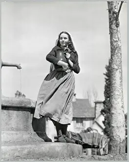 Jennifer Jones Standing By A Well