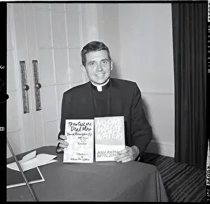 Jesuit Daniel Berrigan Holding Books